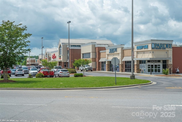 view of building exterior featuring uncovered parking