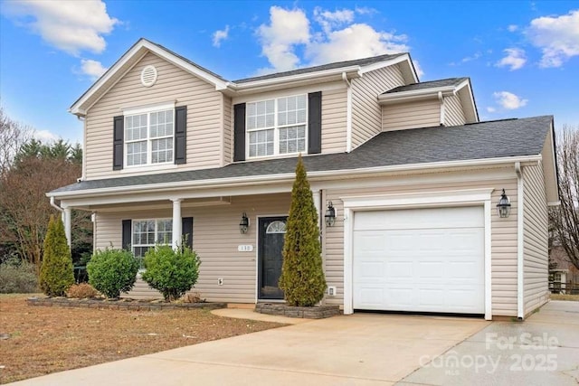 view of front of home with a garage and a porch