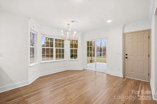 interior space with an inviting chandelier, hardwood / wood-style flooring, and crown molding