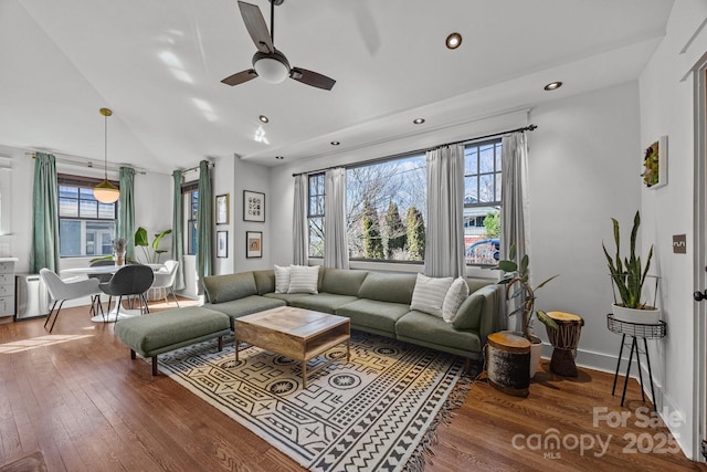 living room with baseboards, lofted ceiling, ceiling fan, wood finished floors, and recessed lighting