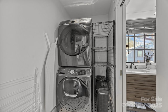 laundry room with stacked washer and dryer, laundry area, and a sink