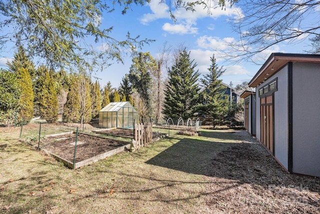 view of yard featuring an exterior structure, a garden, and an outdoor structure