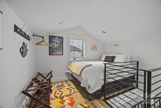 bedroom with lofted ceiling, recessed lighting, wood finished floors, and baseboards