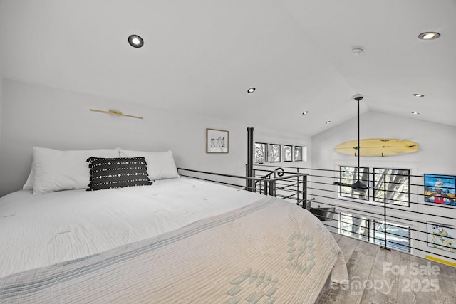 bedroom featuring lofted ceiling, wood finished floors, and recessed lighting