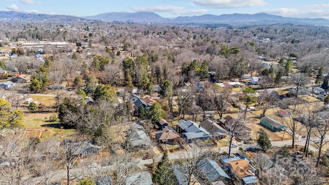 drone / aerial view with a mountain view and a view of trees