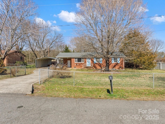 view of front facade featuring brick siding, a fenced front yard, aphalt driveway, a front yard, and a detached carport