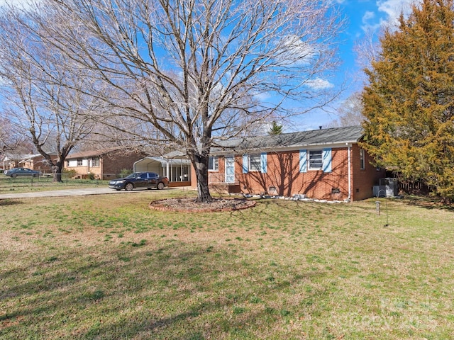 single story home with brick siding, crawl space, and a front yard