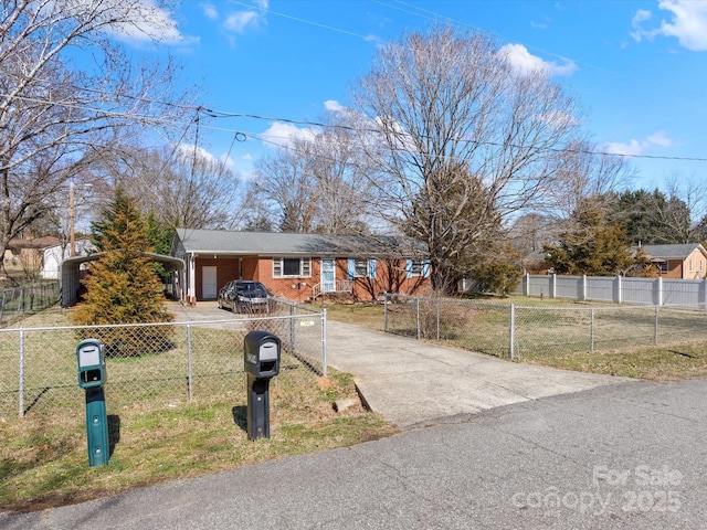 ranch-style home with driveway, brick siding, a fenced front yard, and a front yard