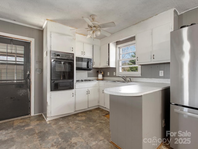 kitchen featuring white cabinets, appliances with stainless steel finishes, a peninsula, light countertops, and a warming drawer