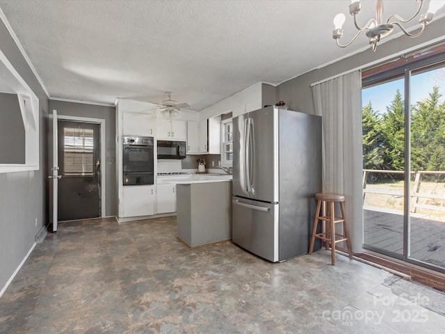 kitchen with freestanding refrigerator, a healthy amount of sunlight, a sink, black microwave, and a peninsula