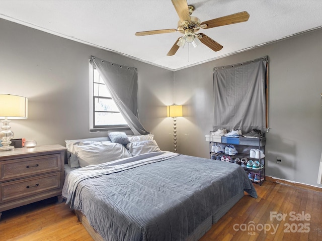 bedroom with ceiling fan and hardwood / wood-style floors