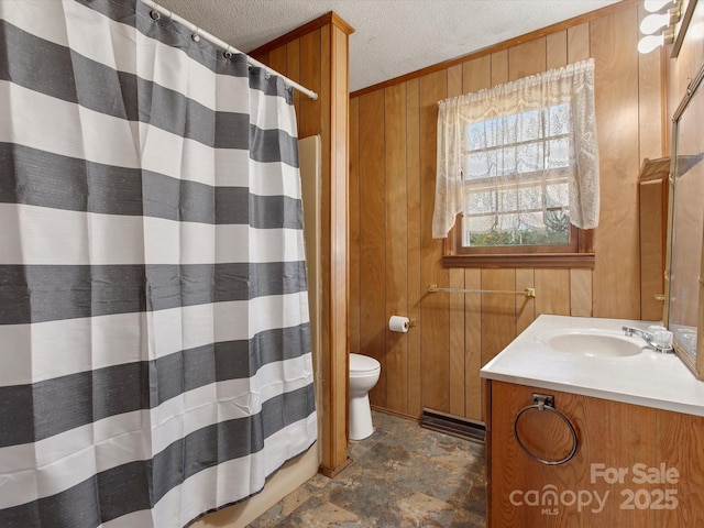 full bath with curtained shower, toilet, wood walls, a textured ceiling, and vanity