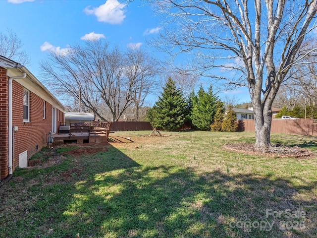 view of yard with fence and a wooden deck