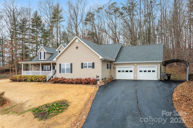 view of front of house featuring covered porch, aphalt driveway, roof with shingles, and an attached garage