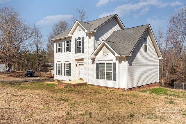 traditional-style home with a shingled roof, crawl space, and a front lawn