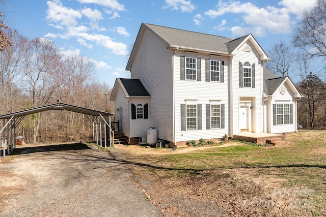 view of front of house with driveway, crawl space, a front yard, and a detached carport