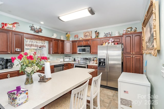 kitchen featuring appliances with stainless steel finishes, a toaster, light countertops, and ornamental molding