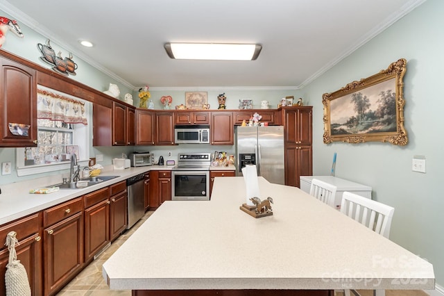 kitchen with a center island, light countertops, appliances with stainless steel finishes, ornamental molding, and a sink