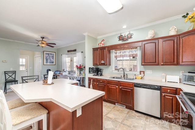 kitchen with visible vents, a breakfast bar, stainless steel appliances, light countertops, and a sink