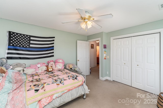 bedroom featuring light colored carpet, a ceiling fan, baseboards, visible vents, and a closet