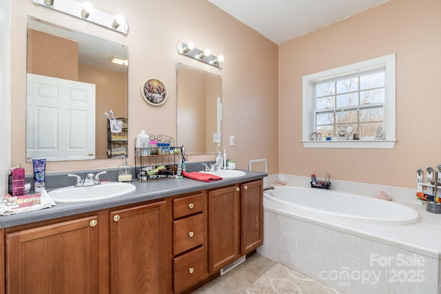 full bathroom featuring a garden tub, double vanity, and a sink