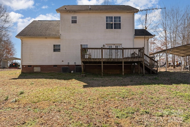 rear view of house featuring a lawn, stairway, crawl space, a deck, and a carport