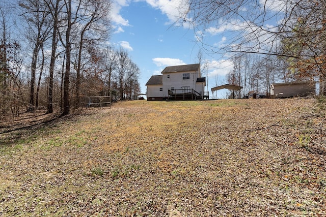 view of yard featuring a deck and a detached carport