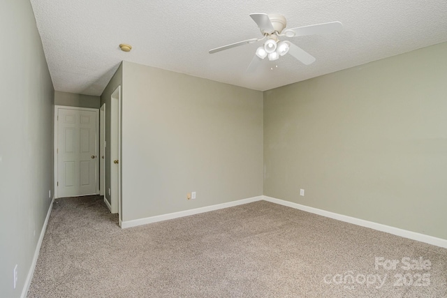 unfurnished bedroom featuring a ceiling fan, light carpet, a textured ceiling, and baseboards