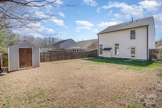 exterior space featuring a shed, a lawn, an outdoor structure, and a fenced backyard