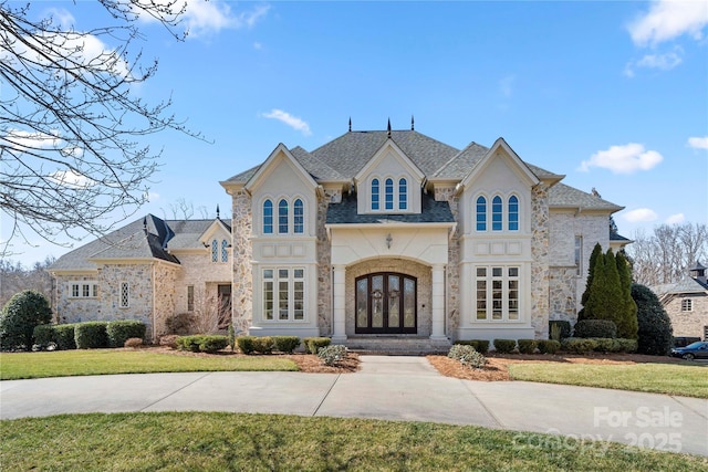 french provincial home with french doors and a front lawn