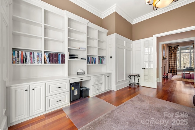 office area with dark wood-style flooring, built in study area, and crown molding