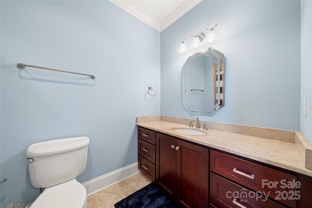 bathroom featuring toilet, ornamental molding, vanity, tile patterned flooring, and baseboards