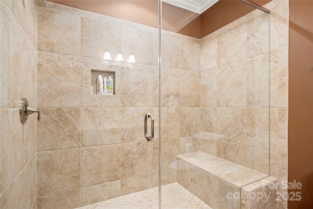 bathroom with crown molding and a shower stall