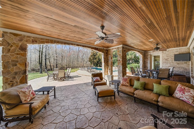 view of patio featuring outdoor dining space, ceiling fan, and an outdoor hangout area