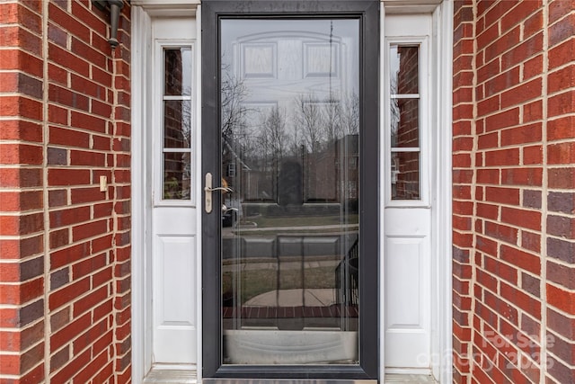 entrance to property with brick siding