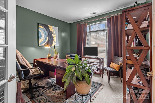 carpeted home office featuring visible vents