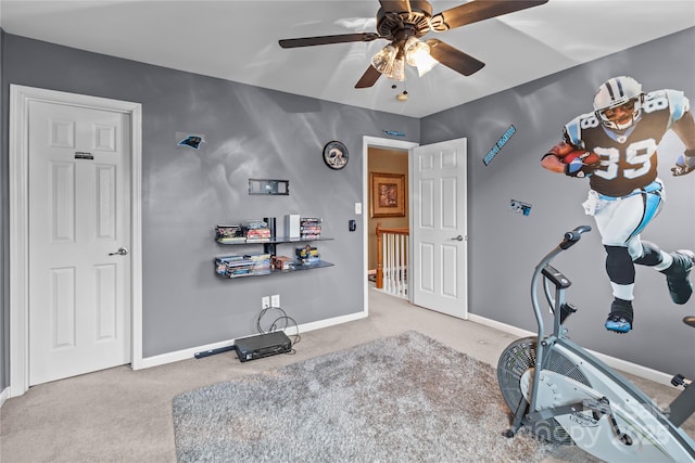 exercise room with ceiling fan, carpet floors, and baseboards