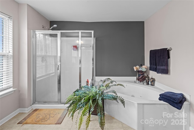 full bathroom with a tub with jets, a stall shower, tile patterned flooring, and baseboards