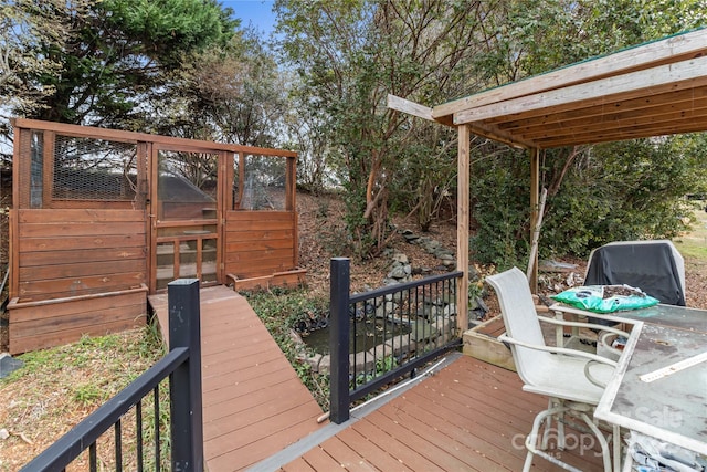 wooden deck featuring an outdoor structure