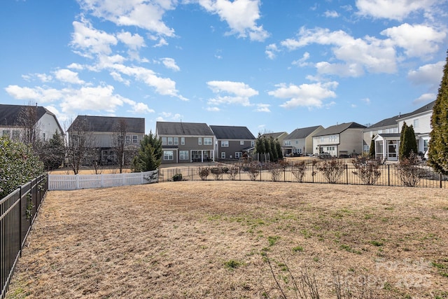 view of yard with a residential view and fence