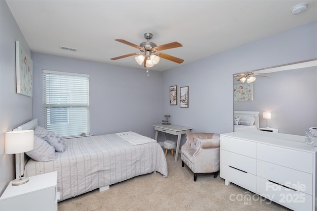 bedroom with ceiling fan, visible vents, and carpet flooring