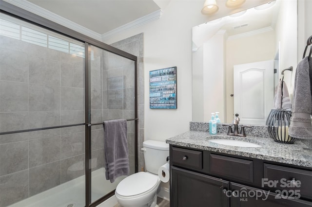 bathroom featuring visible vents, toilet, ornamental molding, vanity, and a shower stall