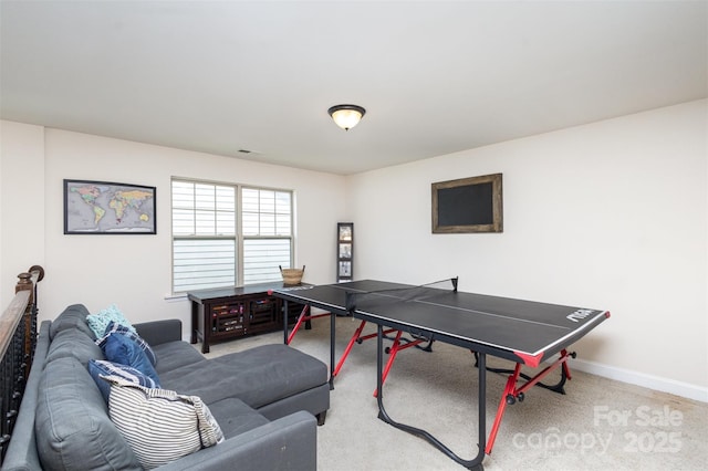 recreation room with carpet and baseboards