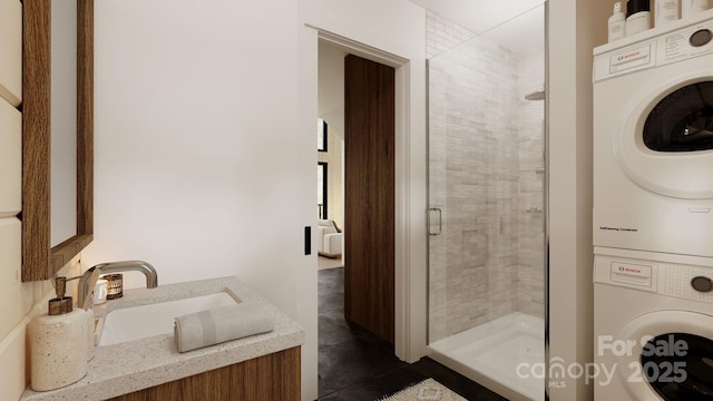 bathroom with stacked washing maching and dryer, vanity, and an enclosed shower