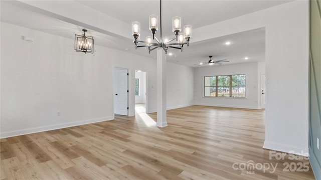 interior space with ceiling fan with notable chandelier, baseboards, light wood finished floors, and recessed lighting