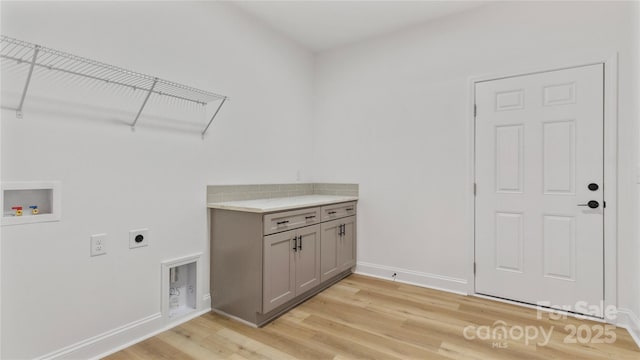 laundry area with light wood-style flooring, baseboards, washer hookup, and electric dryer hookup