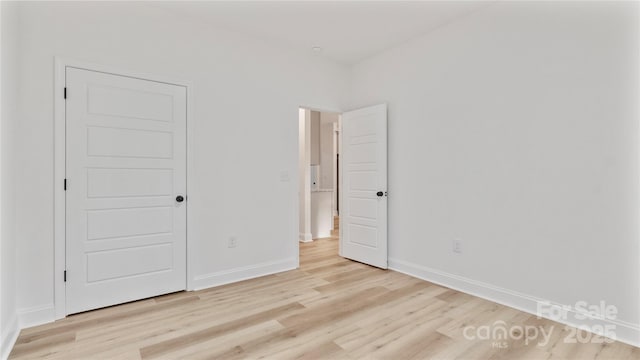 unfurnished bedroom featuring baseboards and light wood-style floors