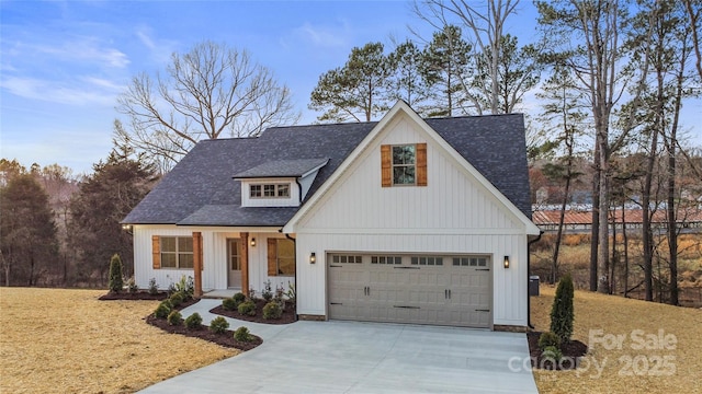 modern farmhouse featuring a garage, a shingled roof, and concrete driveway