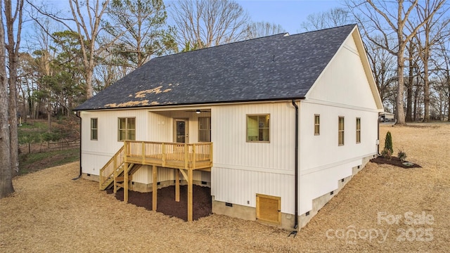 back of property featuring crawl space, a wooden deck, roof with shingles, and stairway