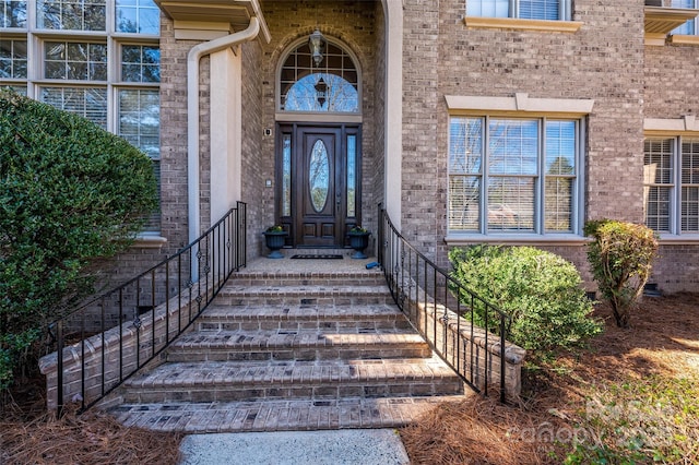 property entrance featuring brick siding